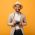 guy-in-beige-suit-and-hat-posing-with-retro-camera-C9CTR6W